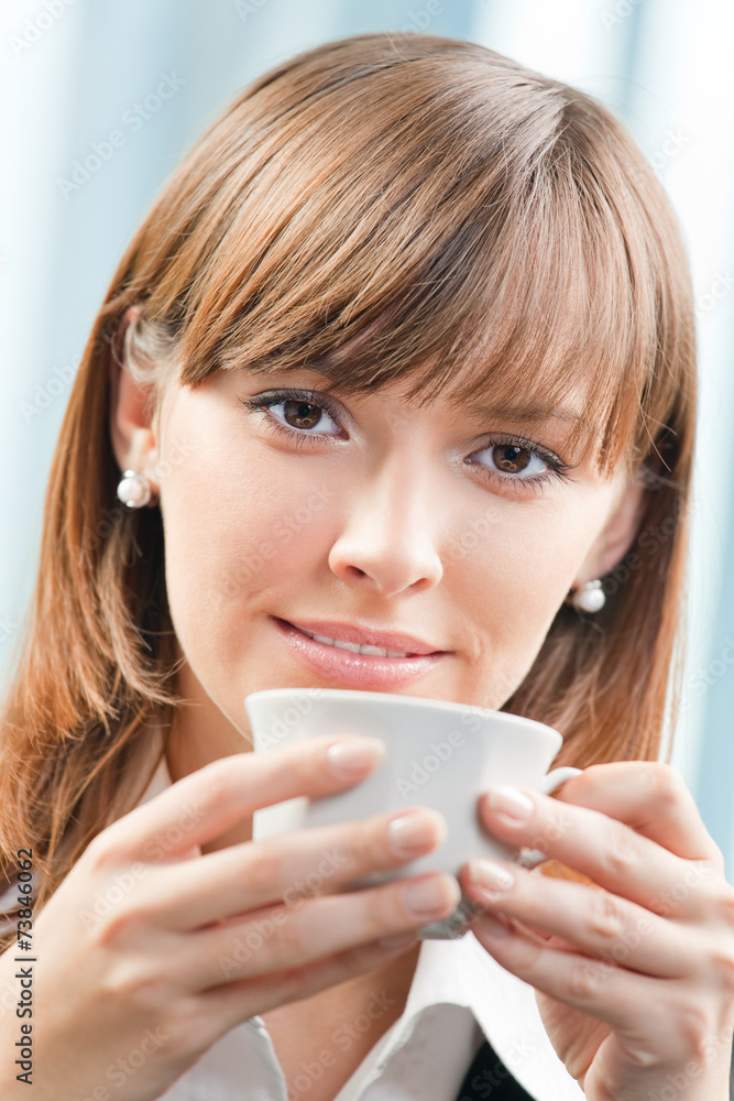 Businesswoman with cup of coffee at office Businesswoman with cup of coffee at office