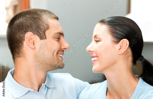 Young happy smiling attractive couple at home