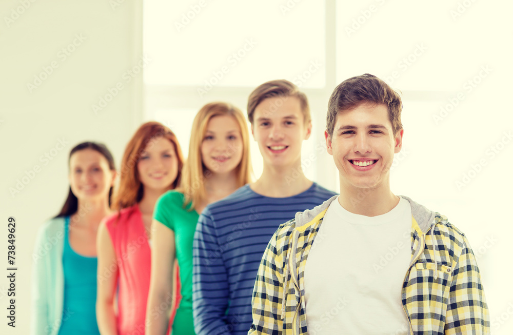 smiling students with teenage boy in front smiling students with teenage boy in front