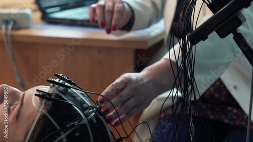 Doctor preparing woman for brain scan in hospital photo