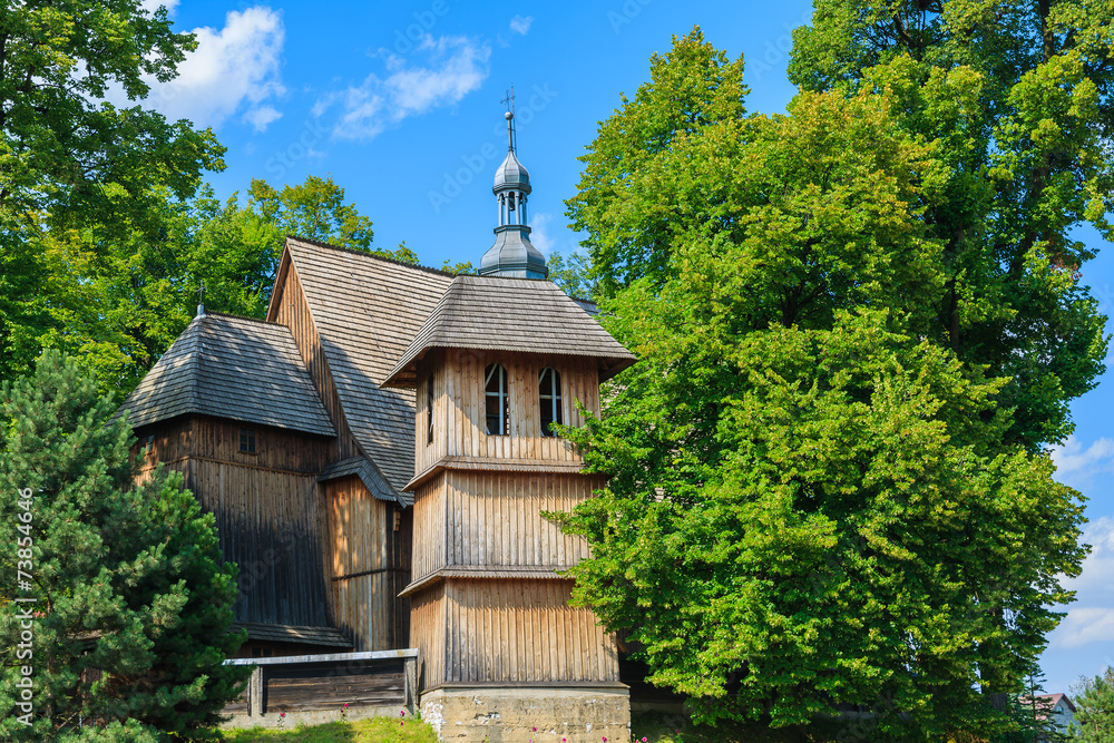 Wooden tower of a church in Raclawice village in summer, Poland