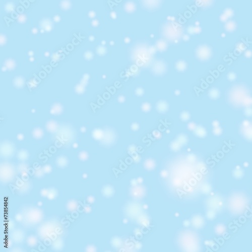 Blurred bokeh christmas background with falling white snowflake