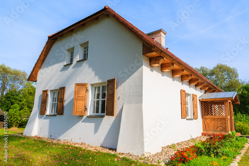 Traditional cottage house in countryside landscape of Poland