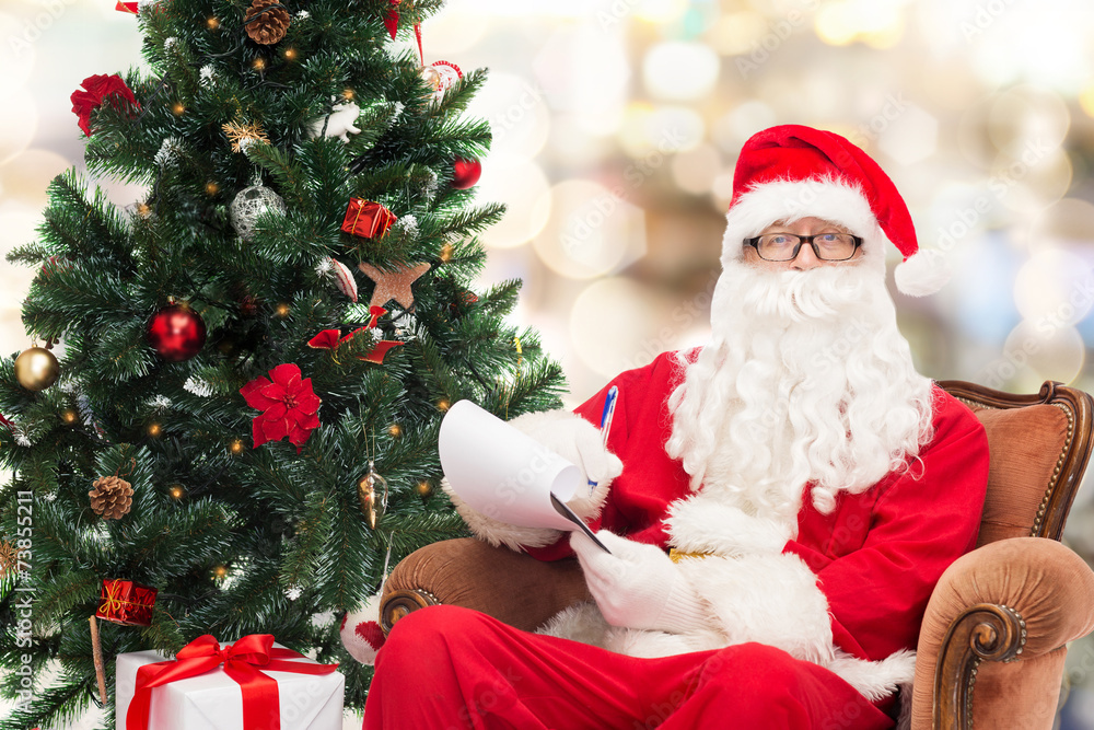 man in costume of santa claus with notepad man in costume of santa claus with notepad
