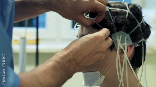 Doctor preparing teenager for brain scan in hospital photo