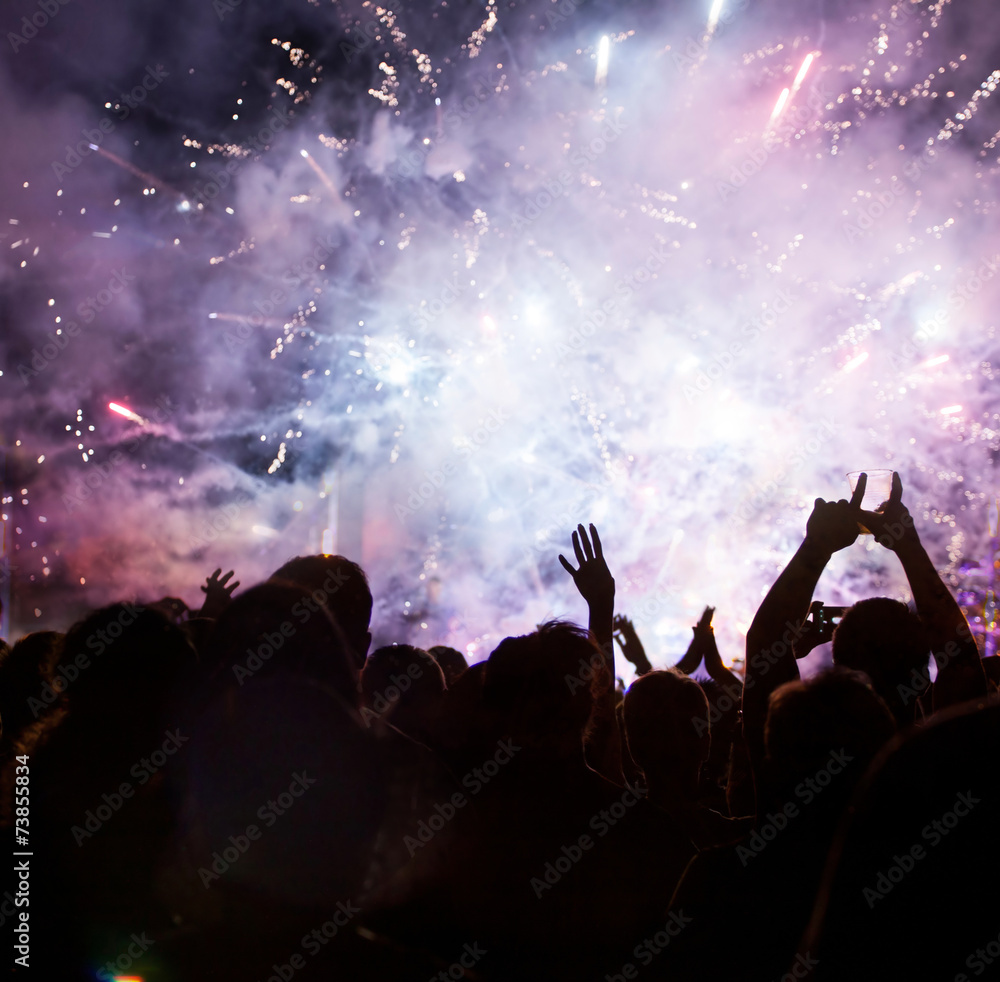 Crowd celebrating the New year with fireworks Crowd celebrating the New year with fireworks