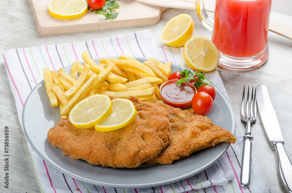 Schnitzel with french fries and a spicy dip Schnitzel with french fries and a spicy dip