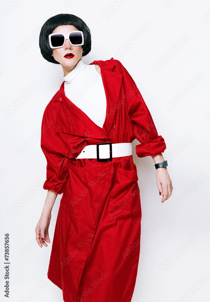 Portrait fashionable brunette in a red cloak on a white backgrou Portrait fashionable brunette in a red cloak on a white backgrou
