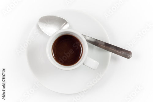 Cup of espresso with spoon on white background, top view