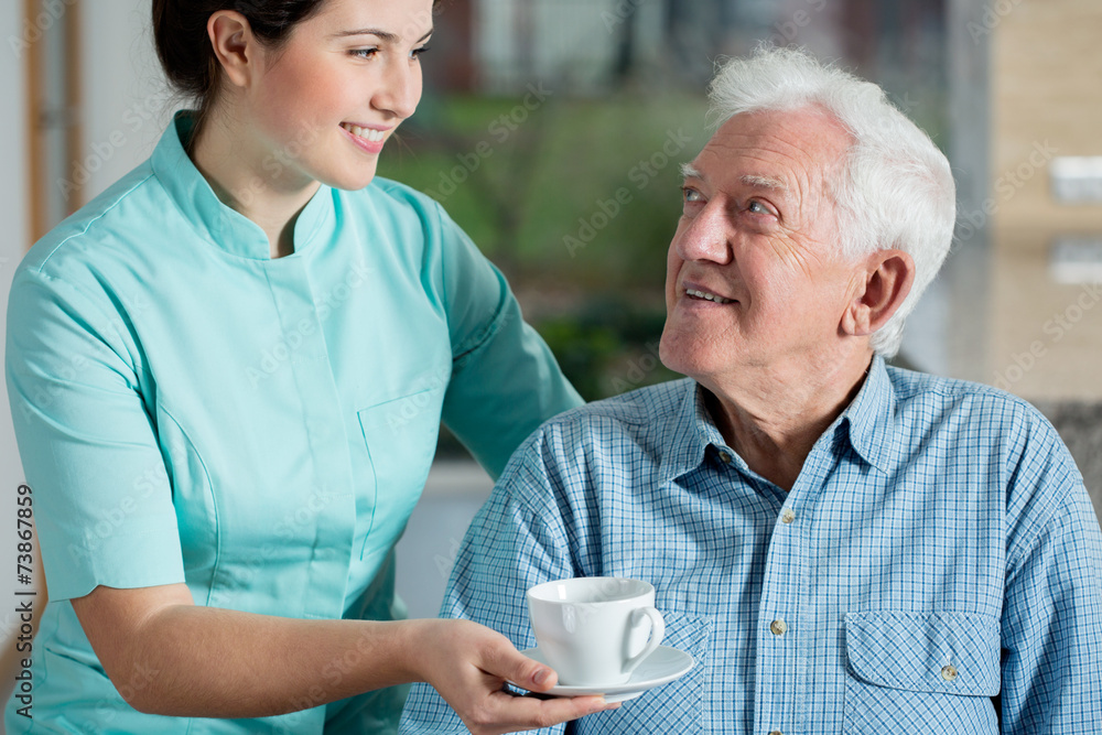 Helper giving cup of coffee Helper giving cup of coffee