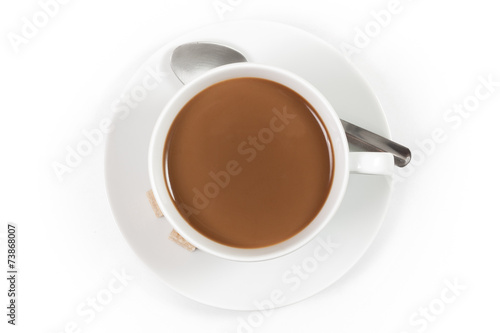 Cup of coffee with milk with spoon on white background, top view