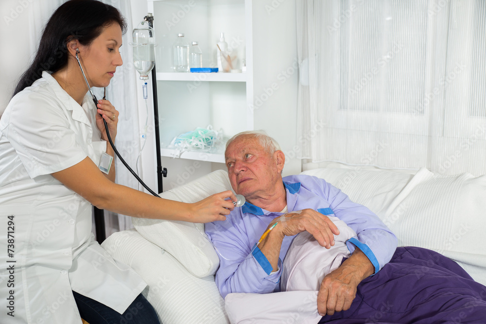 Doctor examining a patient in hospital bed Doctor examining a patient in hospital bed