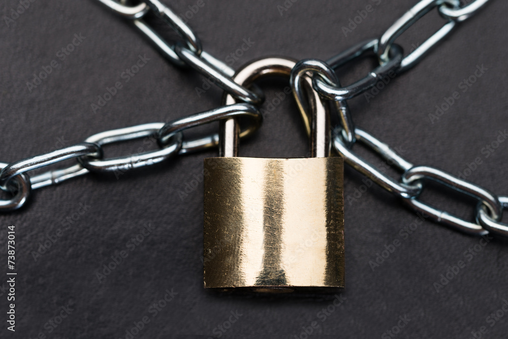 Closeup Of Metallic Padlock And Chains Closeup Of Metallic Padlock And Chains