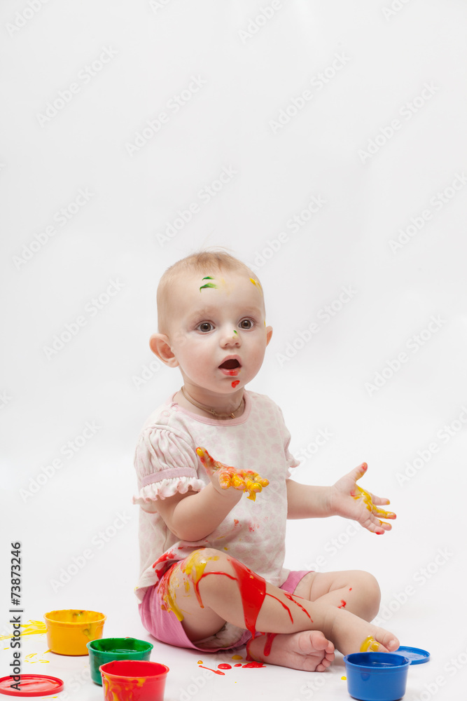 Little girl soiled by multi-colored paints Little girl soiled by multi-colored paints