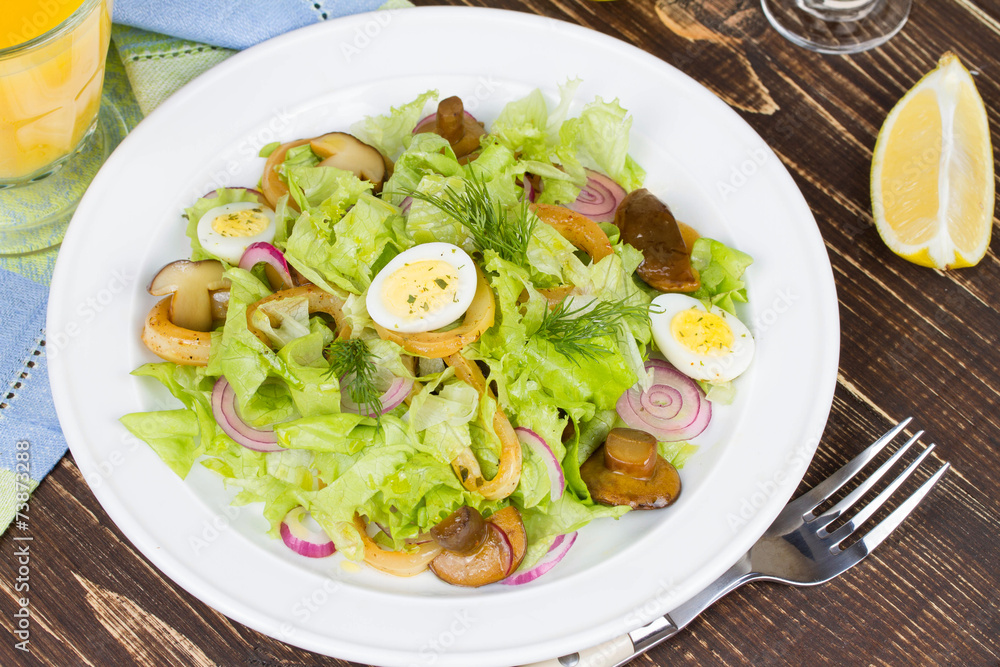 Fresh salad with mushrooms, squid and quail eggs