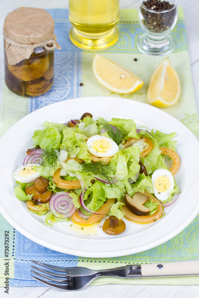 Fresh salad with mushrooms, squid and quail eggs