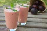 Two glasses of plum smoothie