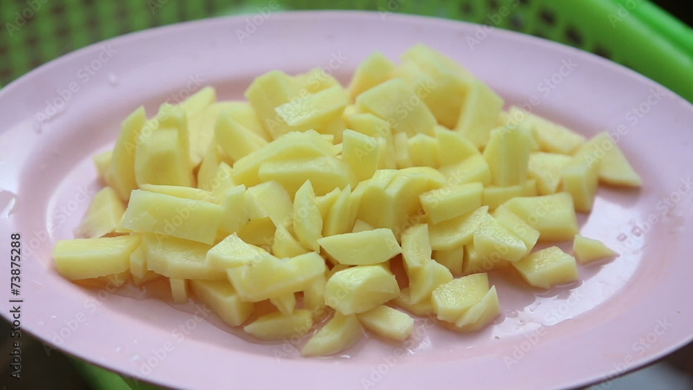 coarsely chopped potatoes lies on a plate close up coarsely chopped potatoes lies on a plate close up