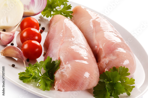 Raw chicken fillets on white background