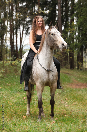 Beautiful girl riding a horse without bridle or saddle © Zuzana Tillerova