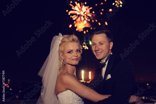 Fotografie Beautiful bridal couple dancing sorrounded by fireworks