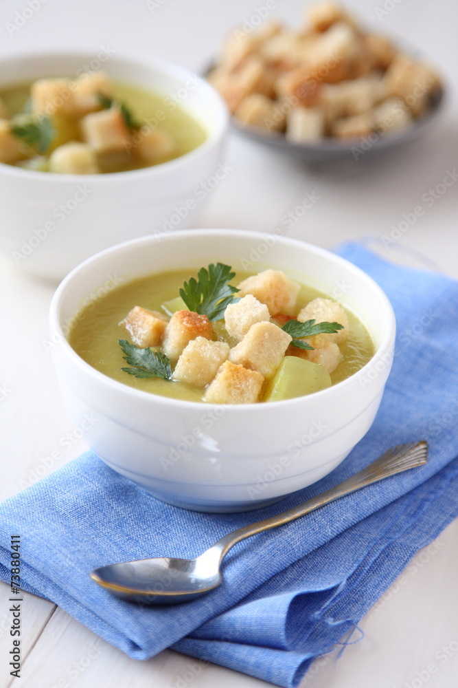 Creamy sweet potato soup with croutons and parsley in white bowl Creamy sweet potato soup with croutons and parsley in white bowl