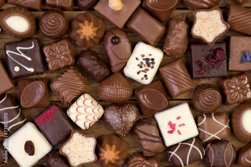 Various chocolates on wooden background