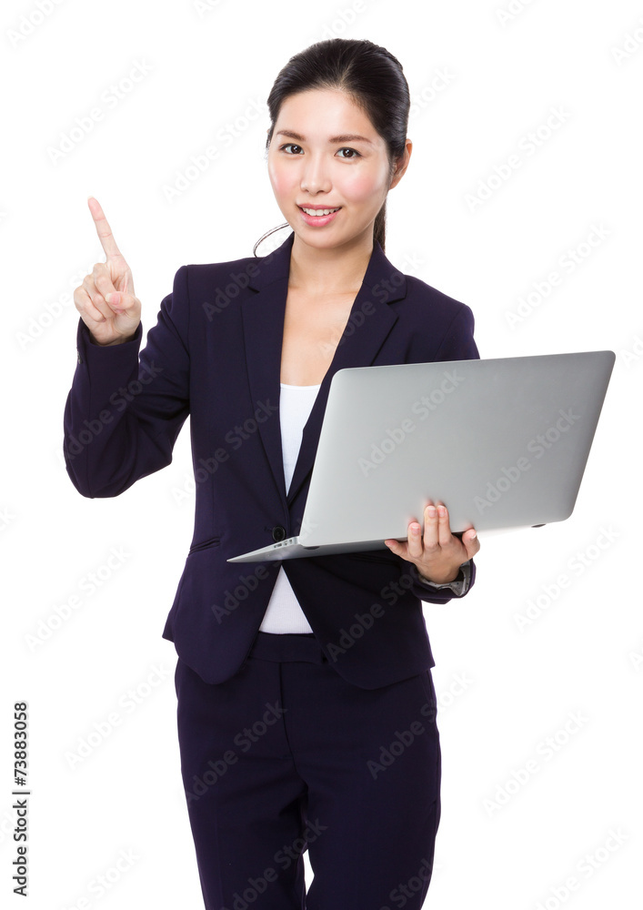 Businesswoman use of laptop and finger point up Businesswoman use of laptop and finger point up