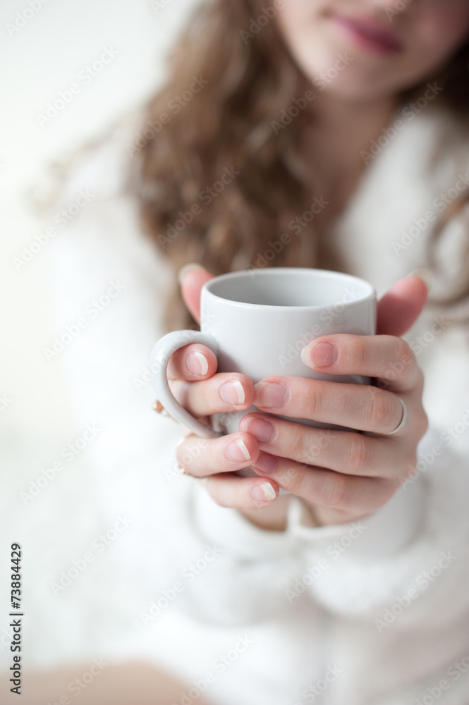 Attractive woman with a cup of coffee on the bed Attractive woman with a cup of coffee on the bed