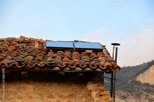 placas solares en una casa de pueblo photo