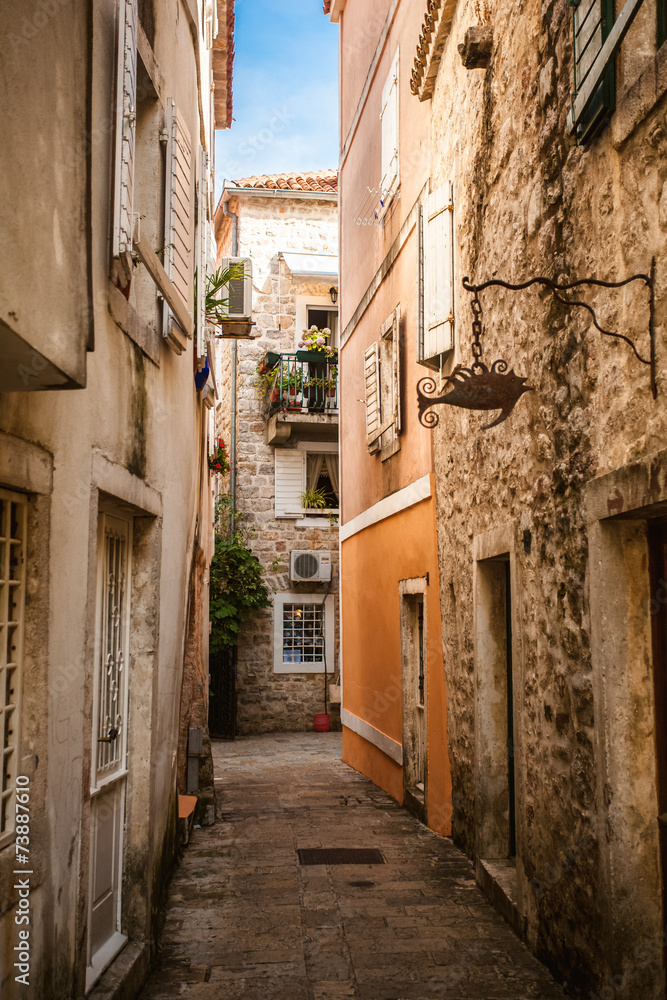 Fototapeta view of old narrow street at sunny day