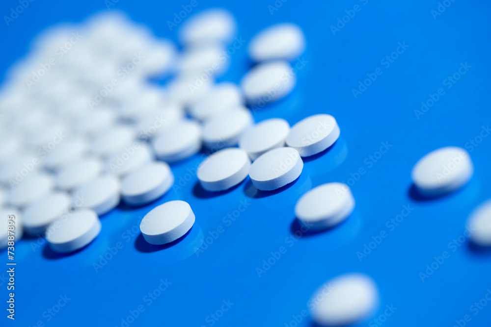 pills. White medical pills on blue background pills. White medical pills on blue background