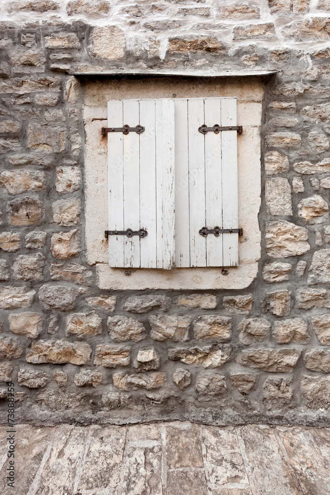 white window shutters at old building white window shutters at old building