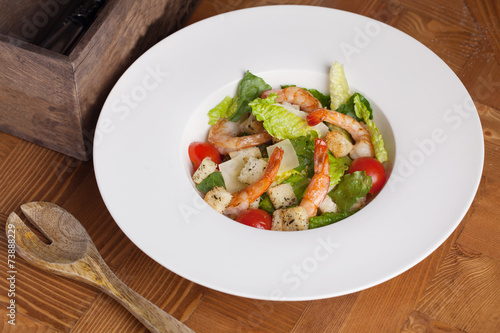 Caesar salad with shrimp on a plate