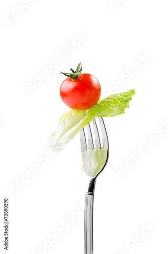 Fresh red tomato and lettuce on a fork with clipping path
