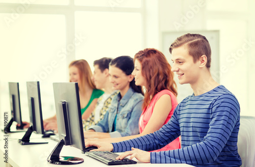 male student with classmates in computer class © Syda Productions