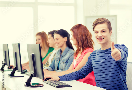 male student with classmates in computer class