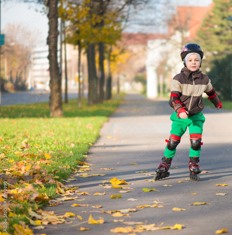 Happy little boy in sunny day on rolle Happy little boy in sunny day on rolle