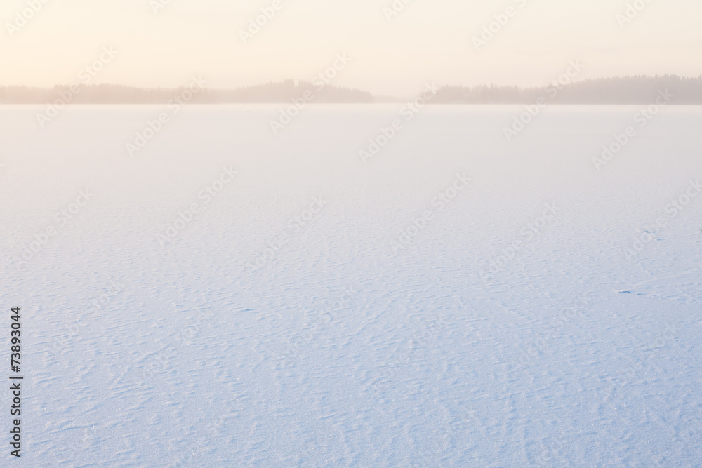 Winter morning view to frozen lake