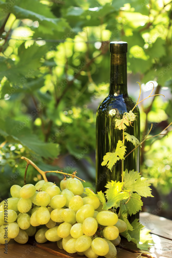 White wine bottle with grape