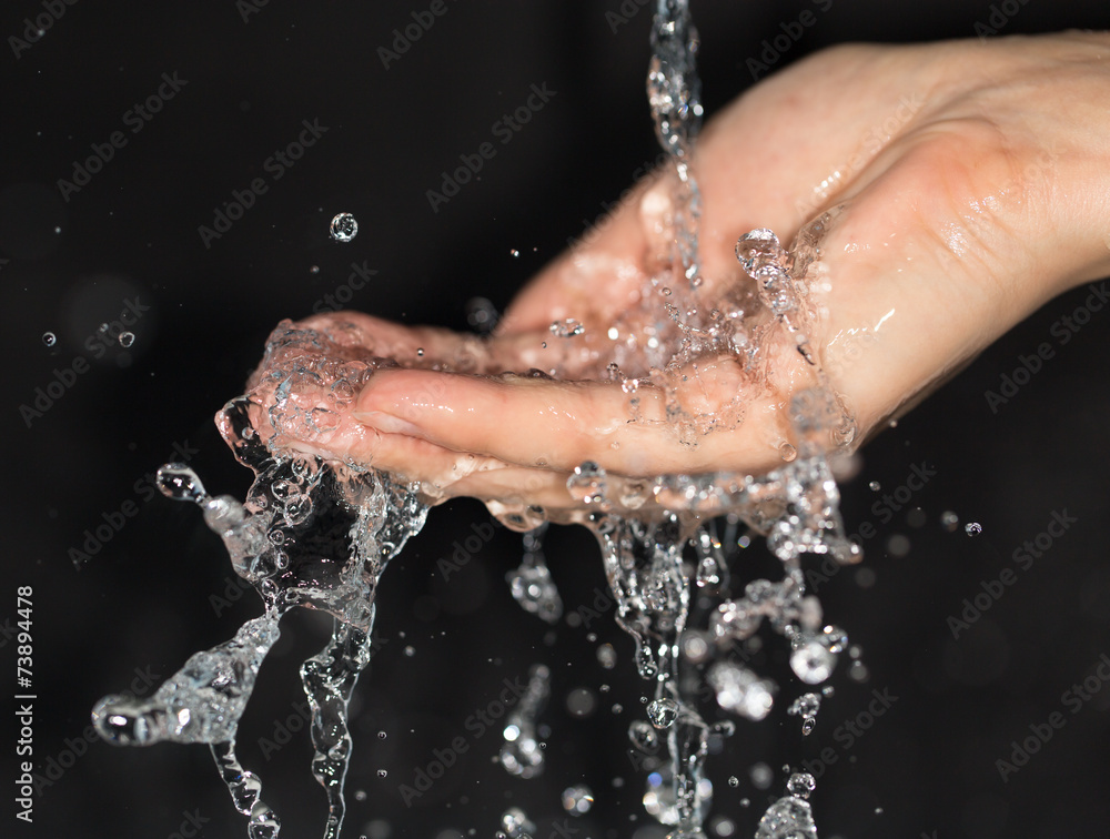 Fototapeta premium hand in water on a black background