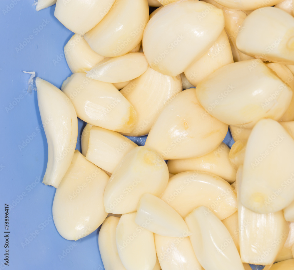 Closeup of peeled cloves of garlic, background Closeup of peeled cloves of garlic, background