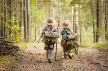 Boys on a forest road with backpacks