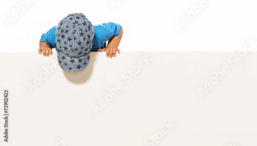 little boy is above on the empty white placard. isolated on whi