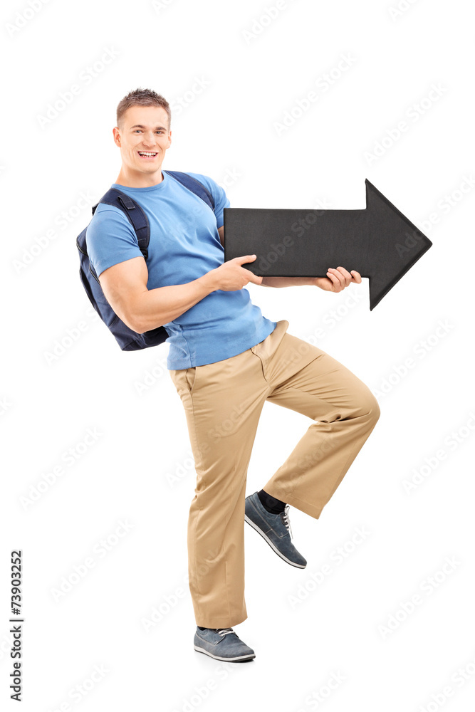 Male student holding a big black arrow Male student holding a big black arrow