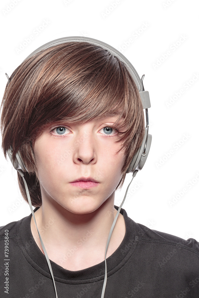 serious teenage boy with headphones, isolated on white serious teenage boy with headphones, isolated on white