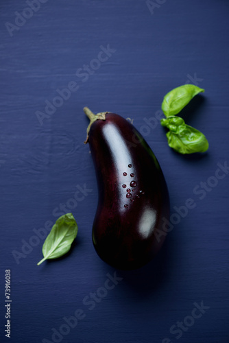Ripe aubergine covered with drops of water, above view