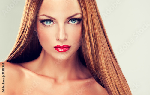 Girl with long straight hair and red lipstick and nails