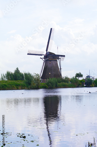 Windmill is reflected in water, Kinderdijk, Netherlands