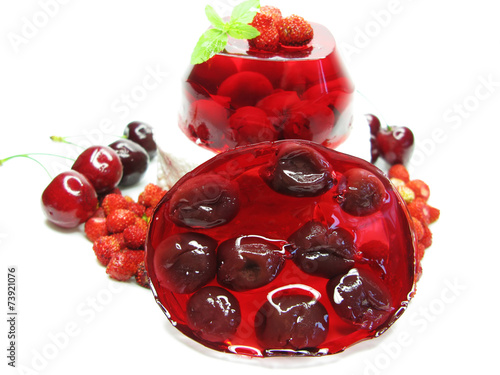 red jelly marmalade dessert with cherry and wild strawberry photo